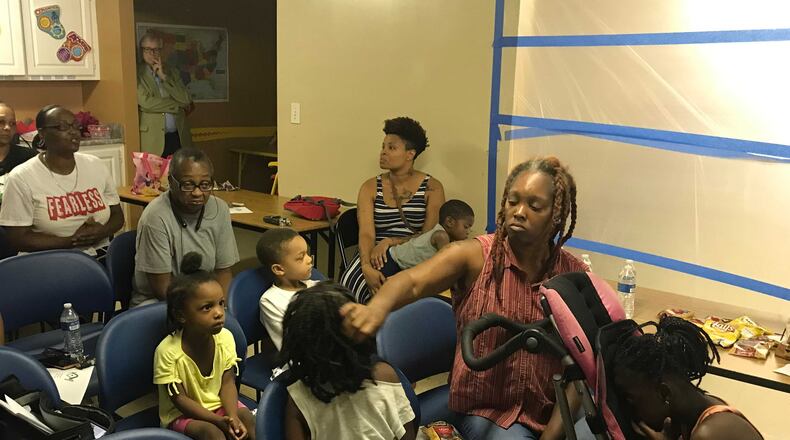 Garnell Hodge, a resident of Kingsley Village, and her daughters, Lonnie, 8, and Fantasia, 4, attended a tenants meeting with police, county officials and management to address housing conditions. Hodge said she is still waiting for management to take care of the mold in her apartment. (Meris Lutz/AJC)