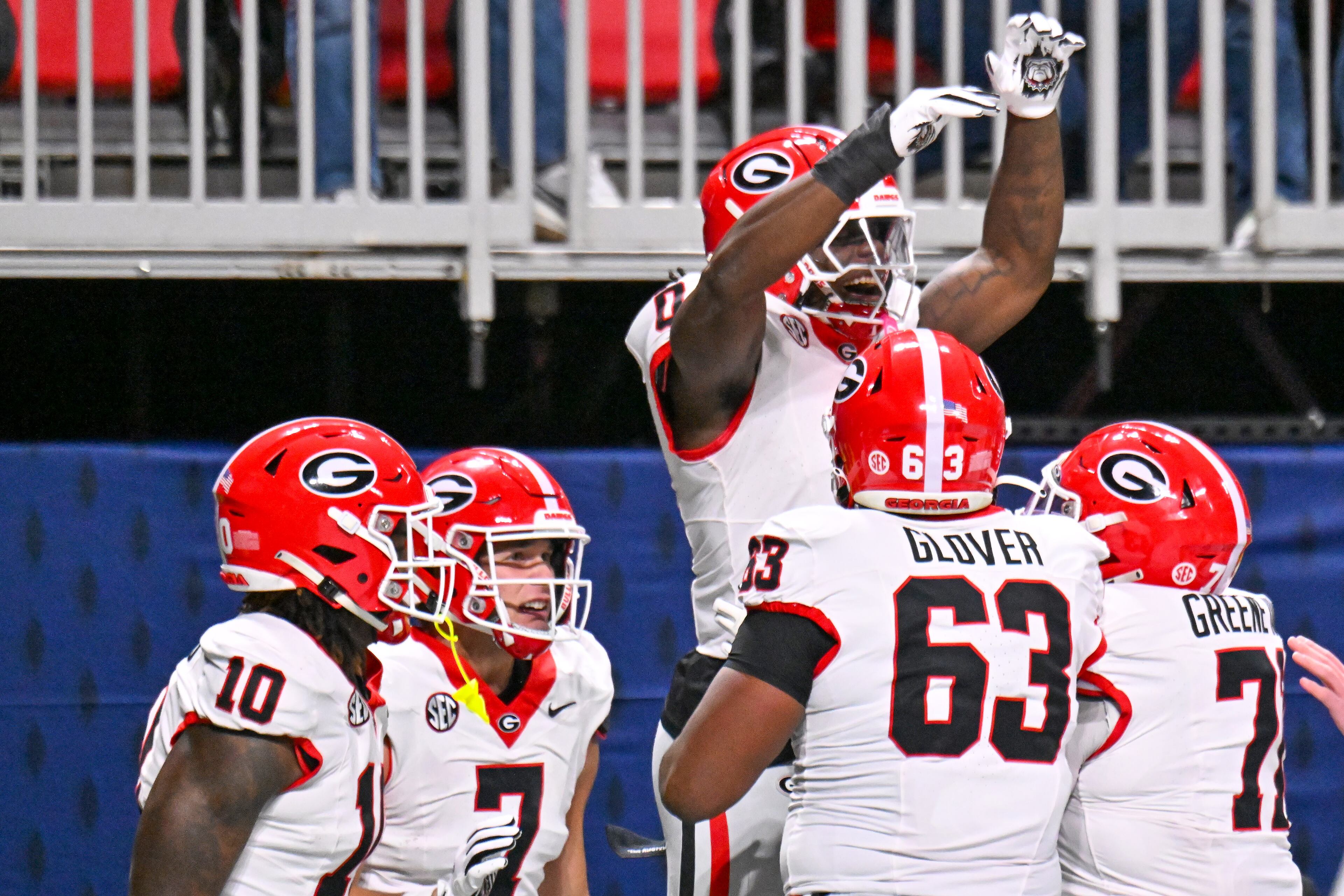 Georgia running back Roderick Robinson II (0) is greeted by Georgia offensive lineman Dontrell Glover (63) and Earnest Greene III (71) after scoring the game's first touchdown on a short run past the Alabama defense during the first quarter of the SEC Championship game at Mercedes-Benz Stadium, Saturday, Dec. 6, 2025, in Atlanta. (Hyosub Shin / AJC)