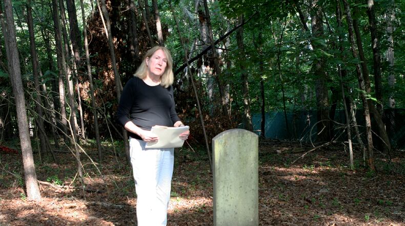 Joan Compton, president of the Johns Creek Historical Society, at the Macedonia African Methodist Church Cemetery in Johns Creek. DAVID IBATA FOR THE AJC