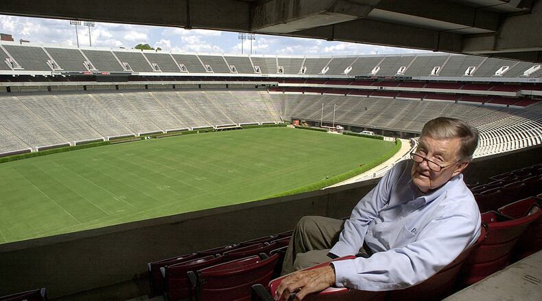 In this file photo taken Aug. 19, 2002, Larry Munson, the play-by play announcer for the Georgia Bulldogs sits inside Sanford Stadium in Athens, Ga.