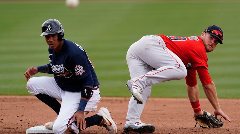 Boston Red Sox shortstop Christian Arroyo (39) watches his throw to first base after forcing out Atlanta Braves' Ehire Adrianza on a ground ball by Ender Inciarte in the fourth inning Saturday, March 20, 2021, in North Port, Fla. Inciarte was safe at first. (John Bazemore/AP)