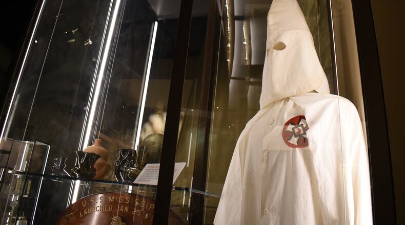 A Ku Klux Klan mask stares out over the Mississippi Museum of History on Friday, March 27, 2026, in Jackson, Miss. (AP Photo/Sophie Bates)