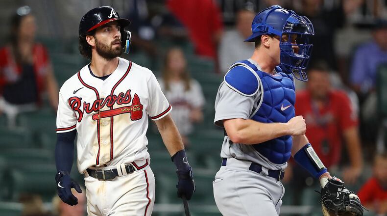 Atlanta Braves shortstop Dansby Swanson strikes out to end the game in the 11th inning Sunday night against the Dodgers. (Curtis Compton / Curtis.Compton@ajc.com)