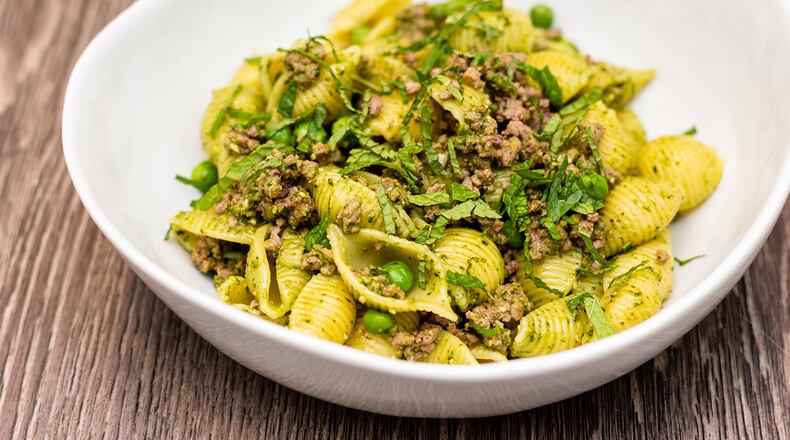 Pasta shells with lamb, pesto and peas.