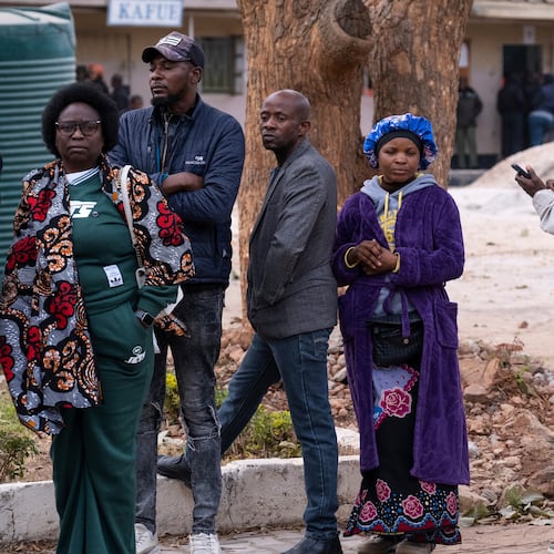 People queue up outside a polling station during a presidential election in Lusaka, Zambia, Thursday, Aug. 13, 2026. (AP Photo/Anita Reed)