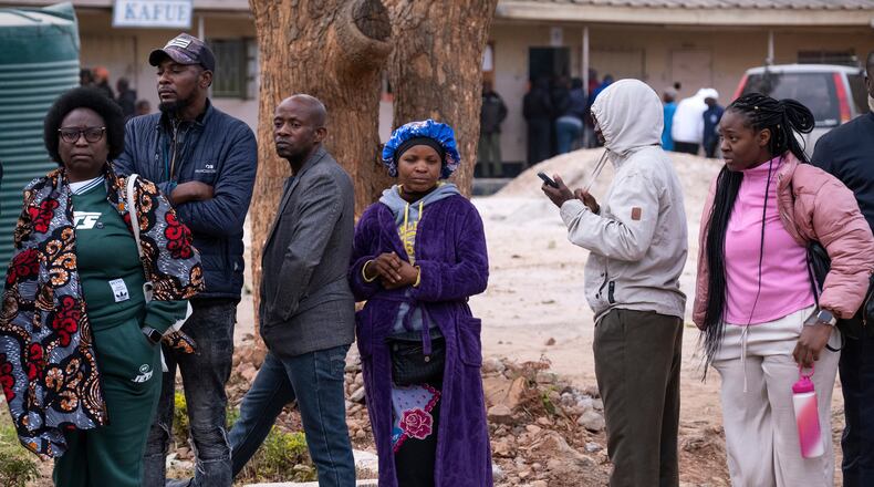 People queue up outside a polling station during a presidential election in Lusaka, Zambia, Thursday, Aug. 13, 2026. (AP Photo/Anita Reed)
