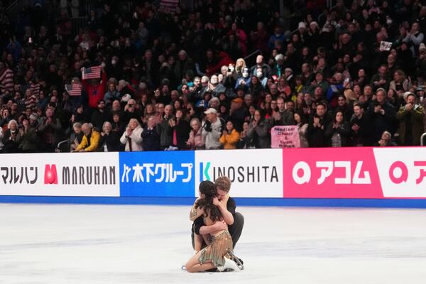 Madison Chock and Evan Bates, of the United States, react after performing during the ice dance free dance program at the figure skating world championships, Saturday, March 29, 2025, in Boston. (AP Photo/Charles Krupa)
