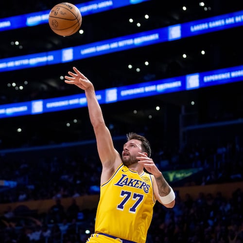 Los Angeles Lakers guard Luka Doncic (77) shoots against Chicago Bulls forward Matas Buzelis (14) during the first half of an NBA basketball game against the Chicago Bulls, Thursday, March 12, 2026, in Los Angeles. (AP Photo/Ethan Swope)