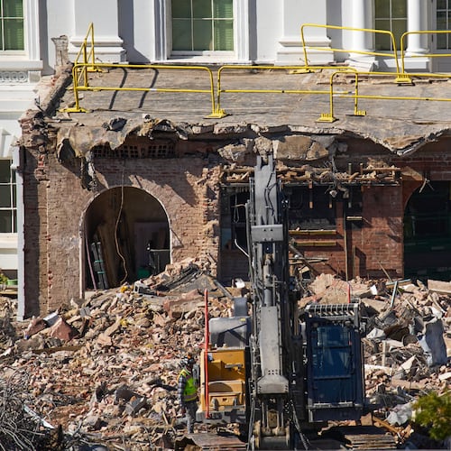FILE - A worker walks among debris from a largely demolished part of the East Wing of the White House, Oct. 23, 2025, in Washington, before construction of a new ballroom. (AP Photo/Jacquelyn Martin)
