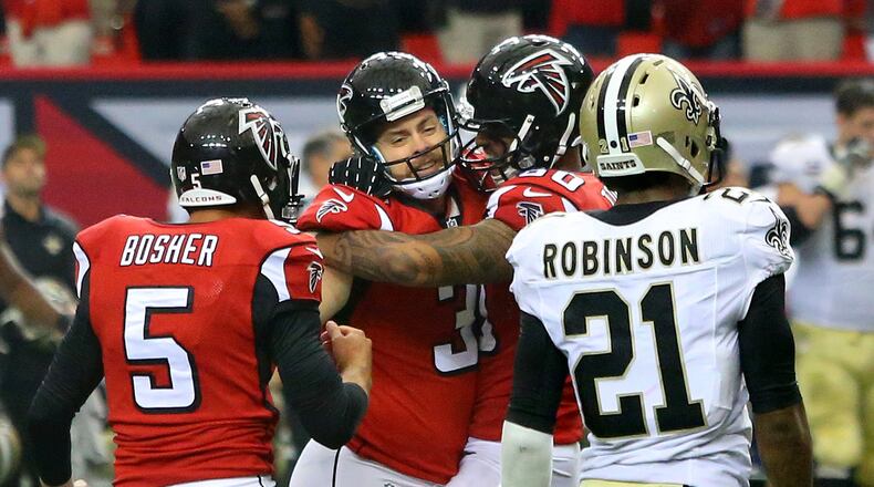 Falcons kicker Matt Bryant (second from left) celebrates his field goal in overtime with Matt Bosher (left) and Levine Toilolo (right) to beat the Saints 37-34 while Saints Partrick Robinson walks of the field on Sunday, Sept. 7, 2014, in Atlanta. CURTIS COMPTON / CCOMPTON@AJC.COM