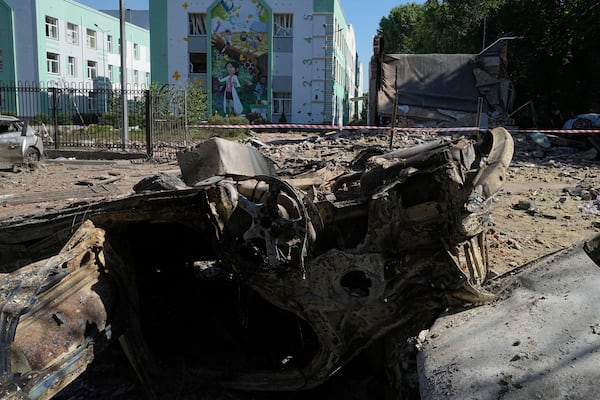 Damaged cars lie in a yard among other debris after a Russian drone and missile attacks in Kyiv, Ukraine, Friday, July 4, 2025. (AP Photo/Efrem Lukatsky)