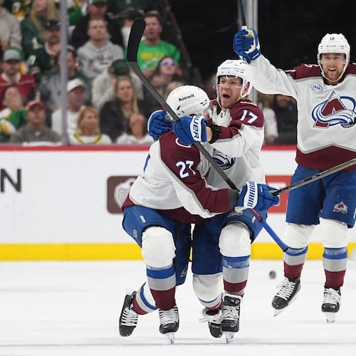 Colorado Avalanche center Parker Kelly, center, celebrates after scoring during the third period of Game 4 in an NHL Stanley Cup hockey second-round playoff series against the Minnesota Wild, Monday, May 11, 2026, in St. Paul, Minn. (AP Photo/Abbie Parr)