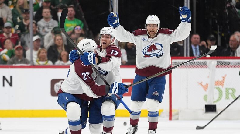 Colorado Avalanche center Parker Kelly, center, celebrates after scoring during the third period of Game 4 in an NHL Stanley Cup hockey second-round playoff series against the Minnesota Wild, Monday, May 11, 2026, in St. Paul, Minn. (AP Photo/Abbie Parr)