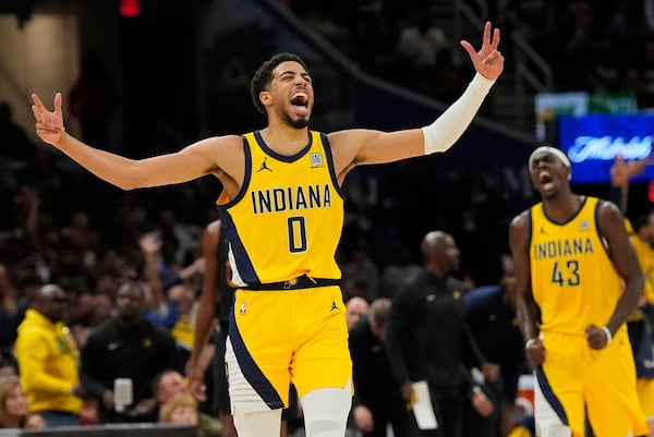 Indiana Pacers guard Tyrese Haliburton, left, celebrates along with forward Pascal Siakam after scoring during the second half in Game 5 of an Eastern Conference semifinal NBA basketball playoff against the Cleveland Cavaliers, Tuesday, May 13, 2025, in Cleveland. (AP Photo/Sue Ogrocki)