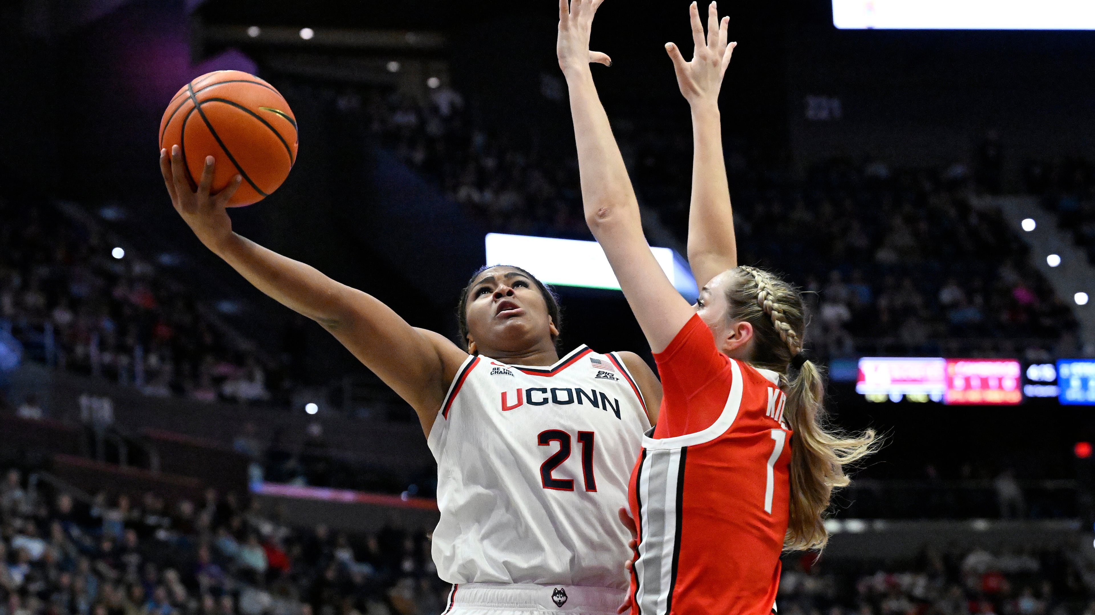 UConn forward Sarah Strong (21) shoots as Ohio State forward Kylee Kitts (1) defends in the first half of an NCAA college basketball game, Sunday, Nov. 16, 2025, in Hartford, Conn. (AP Photo/Jessica Hill)