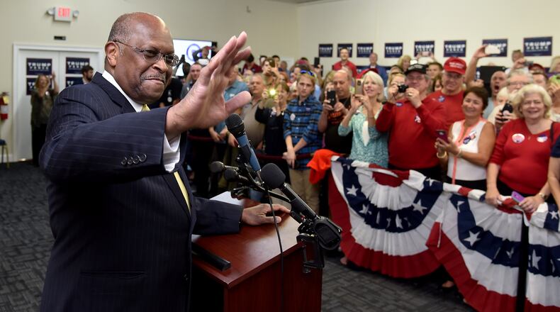 Herman Cain introducing Ivanka and Tiffany Trump, daughters of the future Republican president, during a 2016 rally in Marietta. AJC file