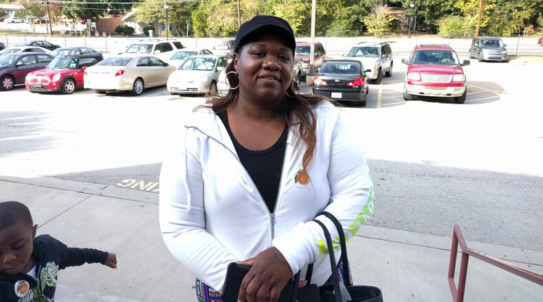 Decatur, Nov. 8, 2016 - Vonita Carter, 45, with grandson D’andre, outside the St. Philip AME precinct south of Decatur. Carter voted for Amendment 1 because she thinks the state should be able to intervene in failing schools. “No child should be left behind,” she said. FIONA TAGAMI/for the AJC