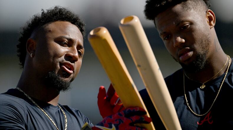 Atlanta Braves second baseman Ozzie Albies (left) and Atlanta Braves right fielder Ronald Acuña Jr. chat as they hold their baseball bats during spring training workouts at CoolToday Park, Saturday, Feb. 14, 2026, in North Port, Fla. (Hyosub Shin/AJC)