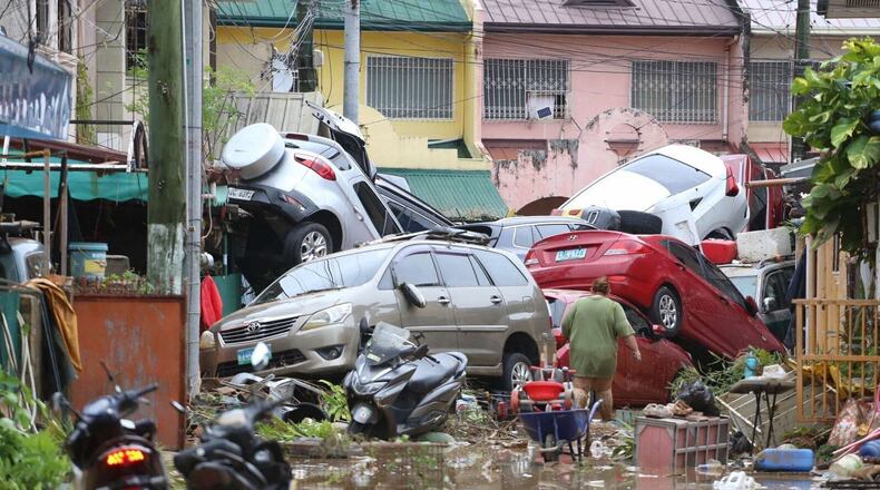 Vehicles lie piled on after flooding caused by Typhoon Kalmaegi in Cebu city, central Philippines, Tuesday, Nov. 4, 2025. (AP Photo/Jacqueline Hernandez)