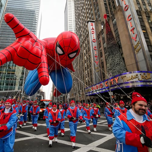 Balloon handlers guide the Spider Man balloon past Radio City Music Hall during the Macy's Thanksgiving Day Parade, Thursday, Nov. 27, 2025, in New York. (AP Photo/Eduardo Munoz Alvarez)