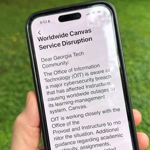 An image of a notice sent by Georgia Tech's information technology department warning students, professors and staff about the cybersecurity breach of the Canvas system it uses for assignments and grading is displayed on a phone, Friday, May 8, 2026, in Decatur, Georgia. (AP Photo/Michael Warren)