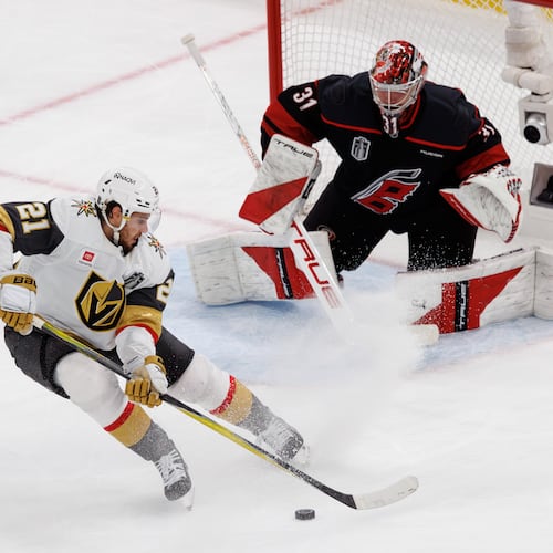 Vegas Golden Knights' Brett Howden (21) handles the puck in front of Carolina Hurricanes goaltender Frederik Andersen (31) during the second period of Game 2 of the NHL hockey Stanley Cup Final series in Raleigh, N.C., Thursday, June 4, 2026. (AP Photo/Ben McKeown)