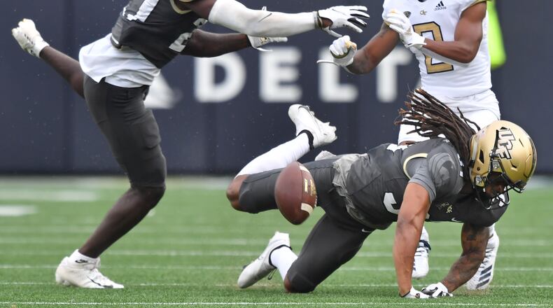 September 19, 2020 Atlanta - University of Central Florida's defensive back Richie Grant (27) and University of Central Florida's defensive back Aaron Robinson (31) try to block a pass intended to Georgia Tech's wide receiver Ahmarean Brown (2) during the second half of an NCAA college football game at Georgia Tech's Bobby Dodd Stadium in Atlanta on Saturday, September 19, 2020. UCF won 49-21 over the Georgia Tech. (Hyosub Shin / Hyosub.Shin@ajc.com)