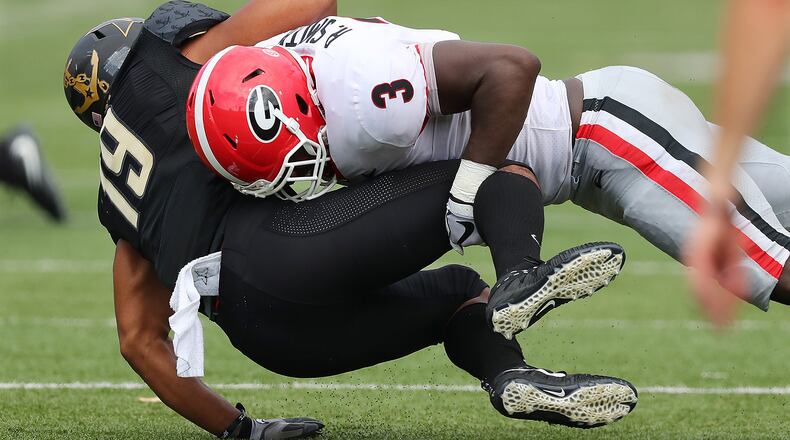 Georgia linebacker Roquan Smith levels Vanderbilt wide receiver C.J. Duncan during the first half in a NCAA college football game on Saturday, October 7, 2017, in Nashville.   Curtis Compton/ccompton@ajc.com