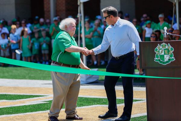 Phillip Beard (left) is congratulated by Lt. Gov. Burt Jones during the ribbon-cutting ceremony for the new Buford High School football stadium on Sunday, July 27, 2025. (Miguel Martinez/AJC)