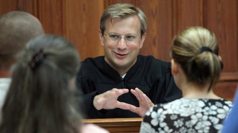 070627 - Sandersville, GA - Judge Tom Rawlings (cq) talks with parents during a DFCS hearing Wednesday morning 6/27/07 in Sandersville. It was Rawlings’ last court appearance in Sandersville before moving to his new position as the state’s child advocate. (Ben Gray/Staff)
