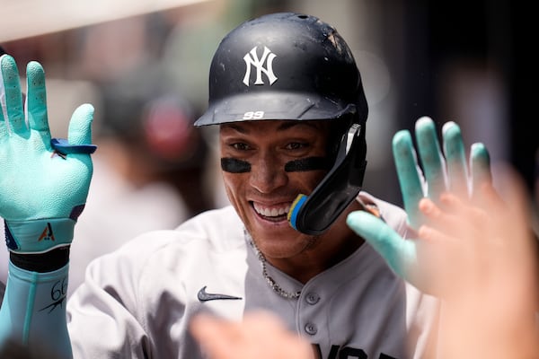 New York Yankees' Aaron Judge (99) celebrates his solo home run against the Atlanta Braves in the first inning of a baseball game, Sunday, July 20, 2025, in Atlanta. (AP Photo/Mike Stewart)