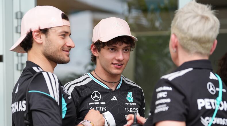 Mercedes driver Andrea Kimi Antonelli, center, of Italy, talks to team members outside a hospitality tent ahead of the Formula One Miami Grand Prix auto race, Thursday, April 30, 2026, in Miami Gardens, Fla. (AP Photo/Rebecca Blackwell)