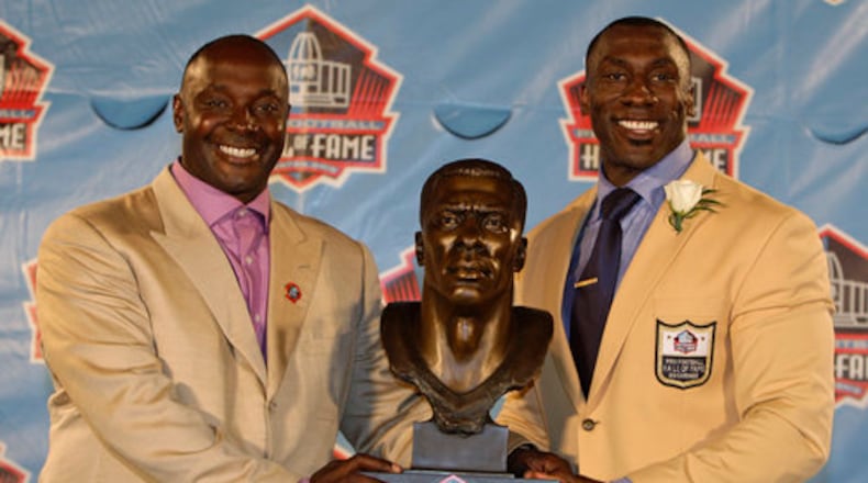 South Georgia native and former Denver and Baltimore tight end Shannon Sharpe (right) and his brother/presenter Sterling Sharpe pose with Shannon's Hall of Fame bust. Now both are in the Hall.