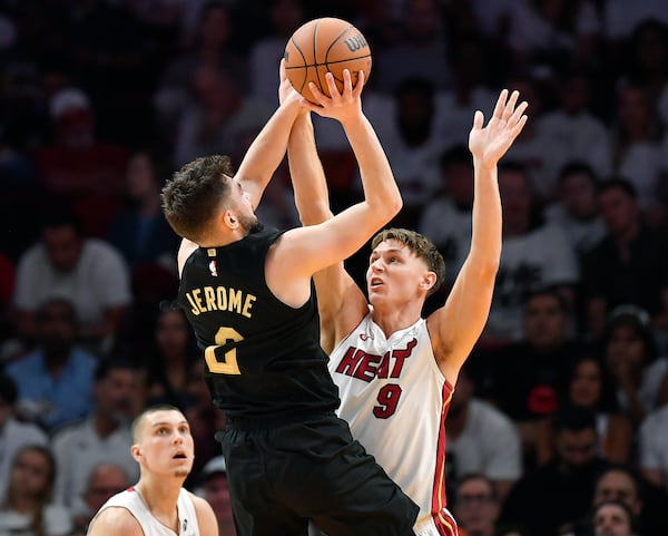 Cleveland Cavaliers guard Ty Jerome (2) shoots over Miami Heat guard Pelle Larsson (9) during the first half in Game 3 of an NBA basketball first-round playoff series, Saturday, April 26, 2025, in Miami. (AP Photo/Michael Laughlin)