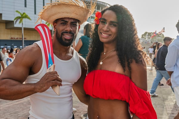Bad Bunny fans pose for a photo before attending his first show of the 30-date concert residency at the Coliseo de Puerto Rico Jose Miguel Agrelot in San Juan, Puerto Rico, Friday, July 11, 2025. (AP Photo/Alejandro Granadillo)