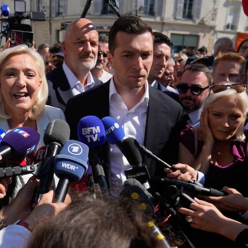Far-right leader Marine Le Pen and Far-right party National Rally president Jordan Bardella answer journalists as they arrive to visit a market in La Fleche, western France Wednesday, July. 8, 2026. (AP Photo/Michel Euler)