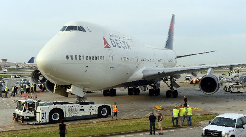 APRIL 30, 2016 ATLANTA Crews move a retired Boeing 747-400 to the Delta Flight museum Saturday, April 30, 2016. Delta Air Lines Ship 6301 made its final journey to Delta’s Atlanta world headquarters campus in preparation for the Delta Flight Museum's latest exhibit featuring the retired aircraft. KENT D. JOHNSON /kdjohnson@ajc.com #delta747experience