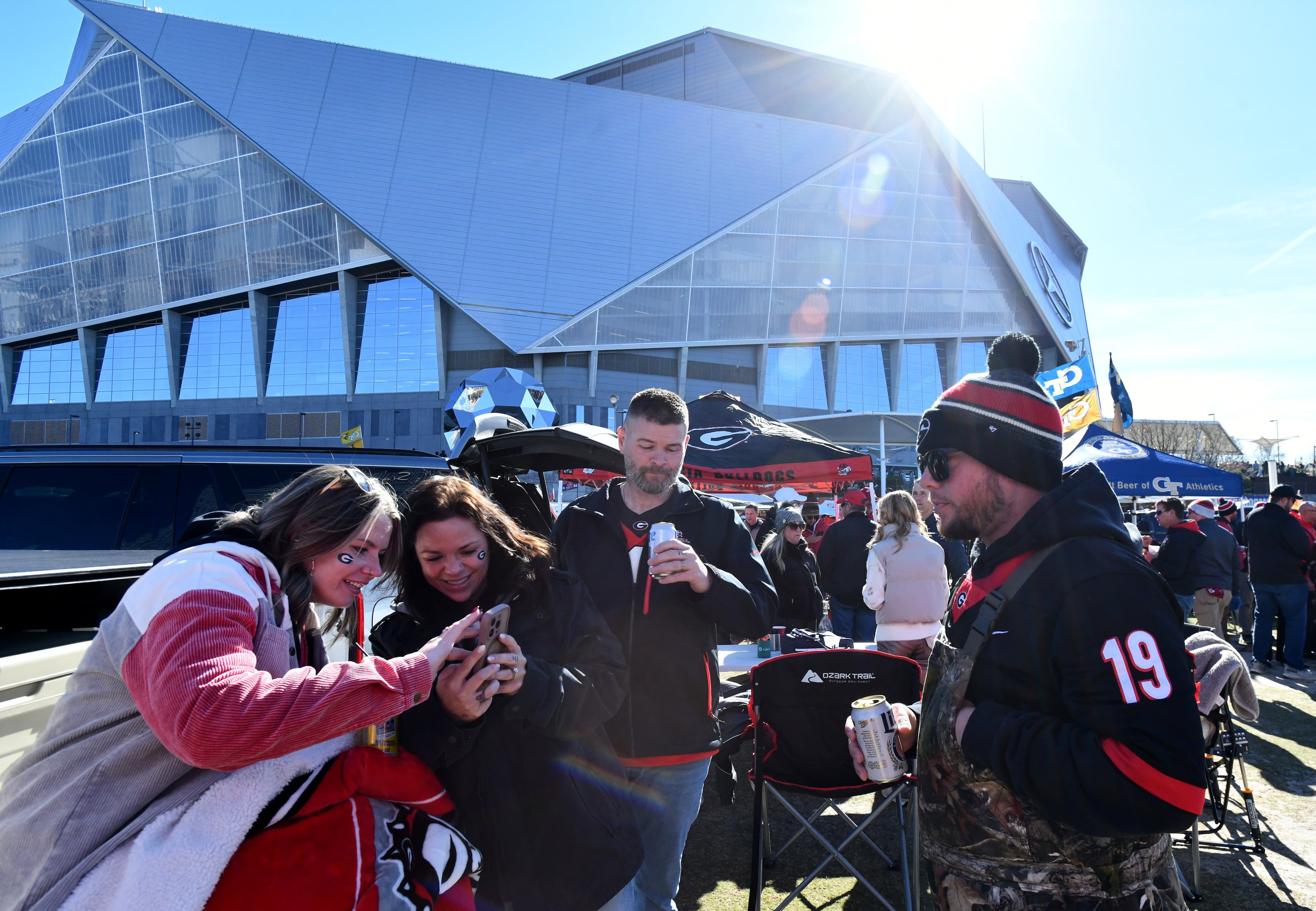 Georgia Tech and Georgia fans enjoy tailgating at The Home Depot Backyard before the start of the Georgia Tech vs Georgia football game at Mercedes-Benz Stadium, Friday, Nov. 28, 2025 in Atlanta. (Hyosub Shin/AJC)