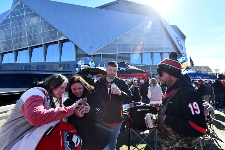 Georgia Tech and Georgia fans enjoy tailgating at The Home Depot Backyard before the start of the Georgia Tech vs Georgia football game at Mercedes-Benz Stadium, Friday, November 28, 2025 in Atlanta. (Hyosub Shin / AJC)