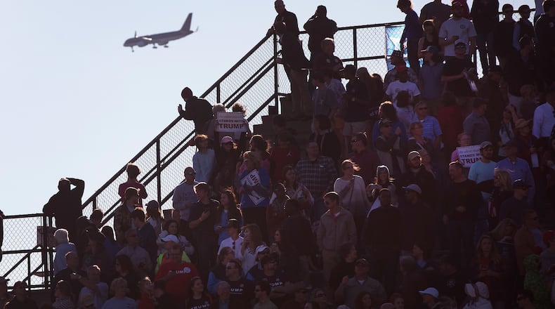 A jet carrying Republican presidential candidate Donald Trump flies over supporters gathered at a campaign rally at a school stadium in Madison, Alabama. Scott Olson/Getty Images