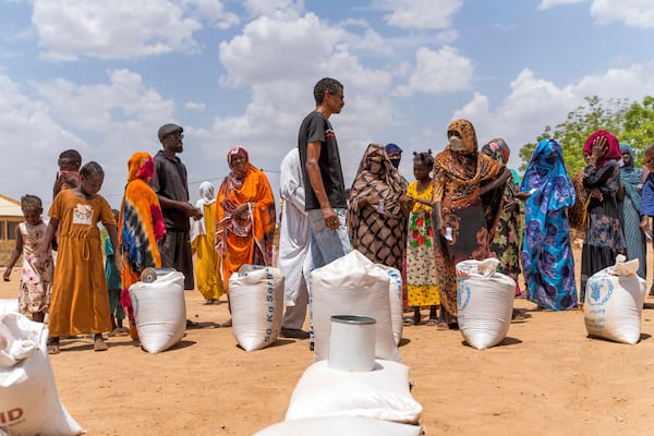 This June 2023 photo provided by the World Food Program shows food distribution by the WFP for internally displaced persons at the Wad Almajzoub farm camp in Wad Medani, Gezira state, Sudan. (Ala Kheir/U.N. Office for the Coordination of Humanitarian Affairs via AP)