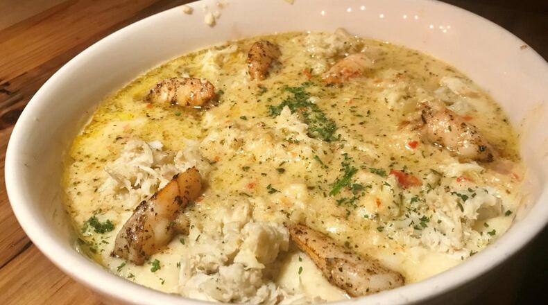 Soul Crab focuses on seafood with a Southern bent. Pictured is its Shrimp and Crab over Grits. LIGAYA FIGUERAS / LFIGUERAS@AJC.COM