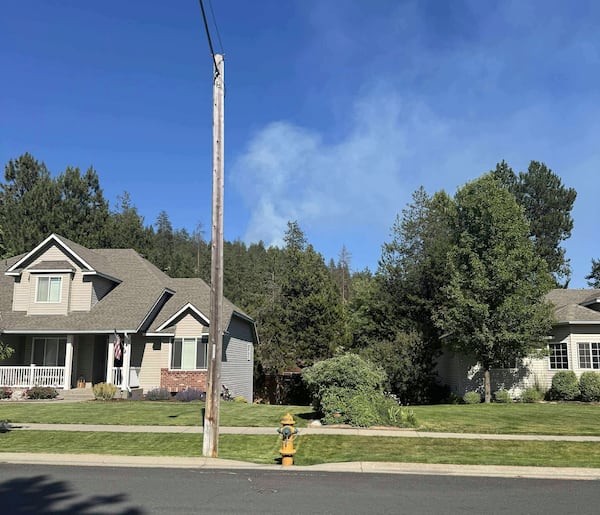 In this photo provided by Mark Lathrop, a blaze burns in a community near Canfield Mountain where a sniper ambushed firefighters responding to the fire, just north of Coeur d'Alene, Idaho, Sunday, June 29, 2025. (Mark Lathrop via AP)