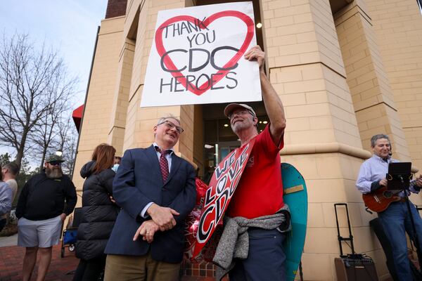 CDC alumnus Dr. Dan Jernigan (left) visits with fellow alum Michael Beach as they gathered to mark the one-year anniversary of the first CDC mass firings outside of the CDC headquarters on Clifton Road in Atlanta on Tuesday, Feb. 10, 2026. (Jason Getz/AJC)