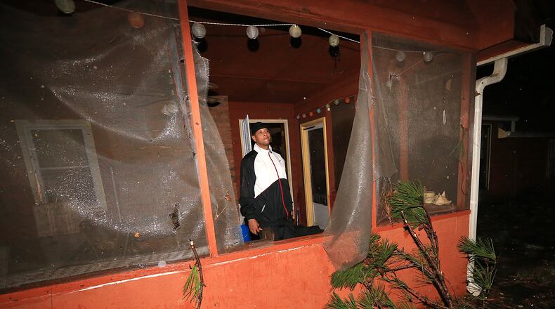 Mike Richardson, 47, checks on damage to his home after a radar-confirmed tornado downed six trees in his yard on John Rivers Road on Wednesday, Nov. 18, 2015, in Fairburn. Richardson said "it felt like the Wizard of Oz. The funnel was right outside the window. It was surreal. I can’t believe the windows didn’t blow.” Curtis Compton / ccompton@ajc.com