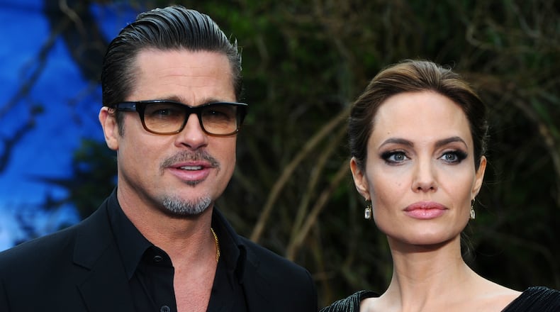 Brad Pitt and Angelina Jolie attend a private reception as costumes and props from Disney's 'Maleficent' are exhibited in support of Great Ormond Street Hospital at Kensington Palace on May 8, 2014 in London, England.