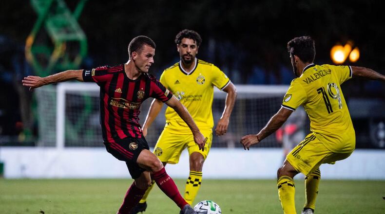 Atlanta United's Brooks Lennon attempts a move around Columbus players during 1-0 loss Tuesday, July 21, 2020, in the MLS tournament in Orlando, Fla.
