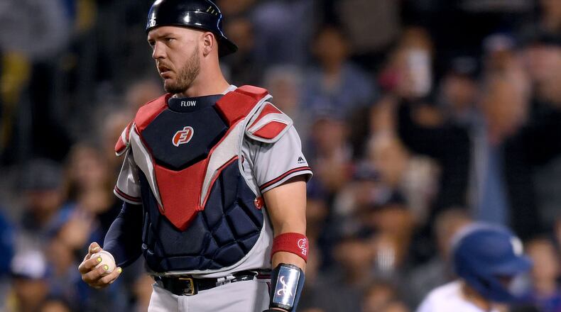 Braves catcher Tyler Flowers holds the ball after a wild pitch allows the Dodgers' Joc Pederson to score, to trail 5-2, during the fifth inning May 8, 2019, at Dodger Stadium in Los Angeles.