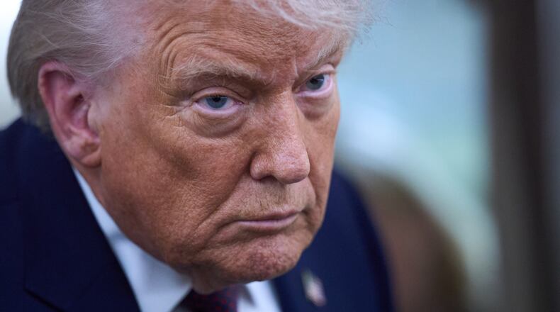 President Donald Trump speaks with reporters aboard Air Force One after leaving the World Economic Forum in Davos for Washington, Thursday, Jan. 22, 2026. (AP Photo/Evan Vucci)