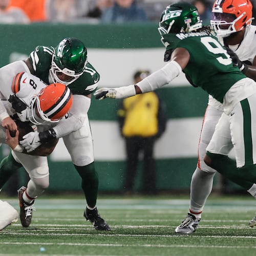 Cleveland Browns quarterback Dillon Gabriel (8) is sacked by New York Jets linebacker Jermaine Johnson (11) in the second half of an NFL football game, Sunday, Nov. 9, 2025, in East Rutherford, N.J. (AP Photo/Adam Hunger)